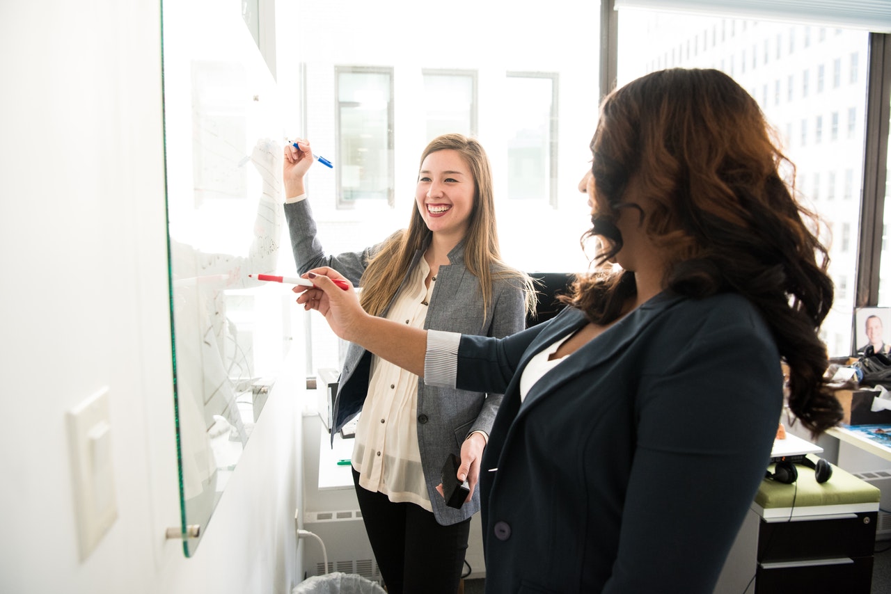 Hr Cloud Two Women In Front Of Dry Erase Board 1181533