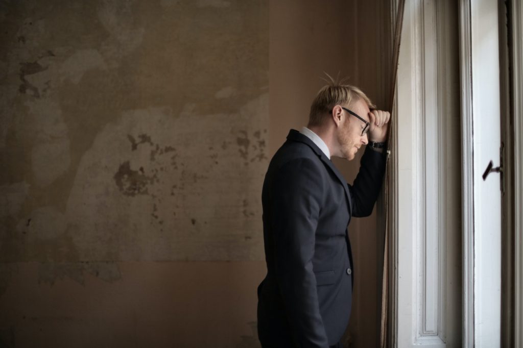How To Help Employees Build Resilience Entrepreneur Standing Near Window 3771129